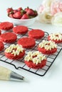 Miniature Red Velvet Cakes with cream cheese frosting and fresh strawberry topping Royalty Free Stock Photo