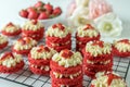 Miniature Red Velvet Cakes with cream cheese frosting and fresh strawberry topping Royalty Free Stock Photo