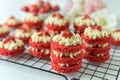 Miniature Red Velvet Cakes with cream cheese frosting and fresh strawberry topping Royalty Free Stock Photo