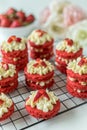 Miniature Red Velvet Cakes with cream cheese frosting and fresh strawberry topping Royalty Free Stock Photo