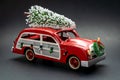 Little red vintage car carrying a Christmas tree on top Royalty Free Stock Photo