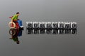 Miniature scale model man in a wheelchair with the word bullying on beads