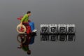 Miniature scale model man in a wheelchair with the word work on beads Royalty Free Stock Photo