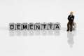 Miniature scale model pensioner with the word dementia