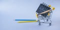 Miniature shopping cart with school supplies. Back to school concept. Royalty Free Stock Photo