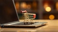 miniature shopping cart on top of a laptop computer Royalty Free Stock Photo