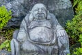 Miniature sitting Buddha in garden