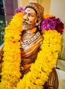 Miniature sitting Statue of Famous king Shivaji in India with selective focus on the face and background blur
