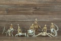 Miniature skeleton army on wood background