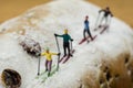 Miniature skier skiing on a cake