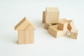 Miniature small house made wooden blocks background of a stack of cubes for assembly.