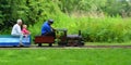 Miniature Steam train giving adults and children rides in the park.