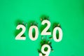 The miniature technicians working.  2019 wooden change to happy 2020 New year concept on green paper background.Success of goal Royalty Free Stock Photo