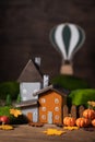 Miniature Thanksgiving little autumn cottages village with air balloon background