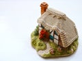 Miniature thatched cottage home in quaint english village