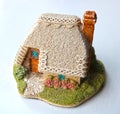 Miniature thatched cottage home in quaint english village Royalty Free Stock Photo