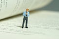 A businessman getting ready, justify the tie above opened book. Image photo