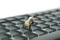 A businessman running above black keyboard carrying briefcase. Isolated on white background Royalty Free Stock Photo