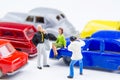 Miniature tiny toys photographer take photos man standing and woman sitting on car bonnet at the public car parking. Royalty Free Stock Photo