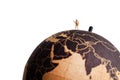 Miniature tourist on top of the globe. Travel concept