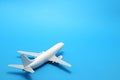 Miniature toy airplane on blue background. Royalty Free Stock Photo