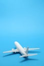 Miniature toy airplane on blue background. Royalty Free Stock Photo