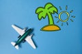 Miniature toy airplane and summer island draw on blue Royalty Free Stock Photo