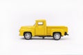 Miniature toy car of yellow color isolated on white background. retro pickup truck Royalty Free Stock Photo