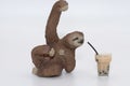 miniature toy figurine of a sloth with a smoothie on a glass