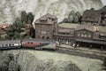 Miniature toy model of modern train crossing town