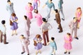 Miniature toy people stand in different poses