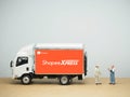 Miniature toy at table with blurred background. Shopee xpress truck.