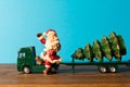 Miniature. Toy truck carries Santa and Christmas tree. The Concept Of Christmas. Empty space for text Royalty Free Stock Photo