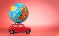 Miniature Toy vintage car carrying a world map balloon.Travel and transport concept. Royalty Free Stock Photo