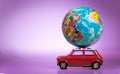 Miniature Toy vintage car carrying a world map balloon.Travel and transport concept. Royalty Free Stock Photo