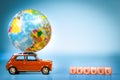 Miniature Toy vintage car carrying a world map balloon and travel word.Travel and transport concept. Royalty Free Stock Photo