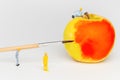 Miniature toy workers paint the apple. Royalty Free Stock Photo