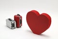 Miniature two suitcases and a red heart on white background. Royalty Free Stock Photo