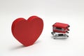 Miniature two suitcases and a red heart on white background. Concept of honeymoon by airplane. Royalty Free Stock Photo