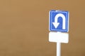 Miniature U-Turn Sign on Brown Background Ã¢â¬\' Traffic Direction Concept Royalty Free Stock Photo