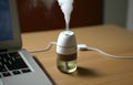 Miniature Usb Humidifier Near Laptop. Generative AI Royalty Free Stock Photo