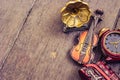 Miniature violin, clocks, train and gramaphone on wooden floor