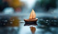 A miniature walnut shell boat with a leaf sail glides on a reflective puddle, creating a tranquil autumn scene. Royalty Free Stock Photo