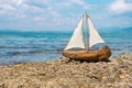 Toy boat in the sea waves. Travel concept. Sailer on beautiful seascape background. Water sports concept. Fascinating