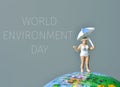 Miniature woman and text world environment day