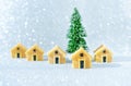 Miniature wooden cottages by a toy Christmas tree Royalty Free Stock Photo