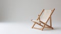 Miniature wooden deck chair on a plain background, suggesting simplicity and relaxation