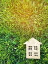 Miniature wooden house on green grass. Real estate concept. Modern housing. Eco-friendly and energy efficient house. Buying a home Royalty Free Stock Photo