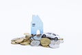 Miniature wooden house and model car on coins stack isolate on white background Royalty Free Stock Photo