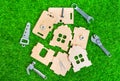 Miniature Wooden House Parts and Hand Tool Replicas on a Lawn